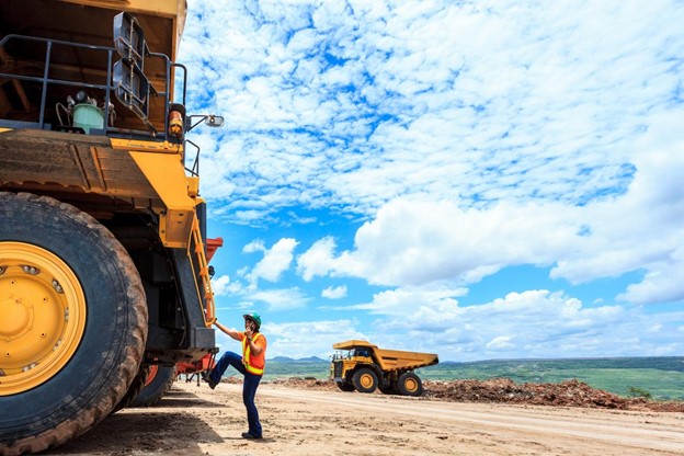 A wide shot of one of the commercial truck drivers entering his vehicle.